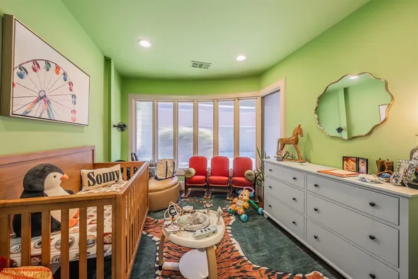 a bedroom with furniture and a large window