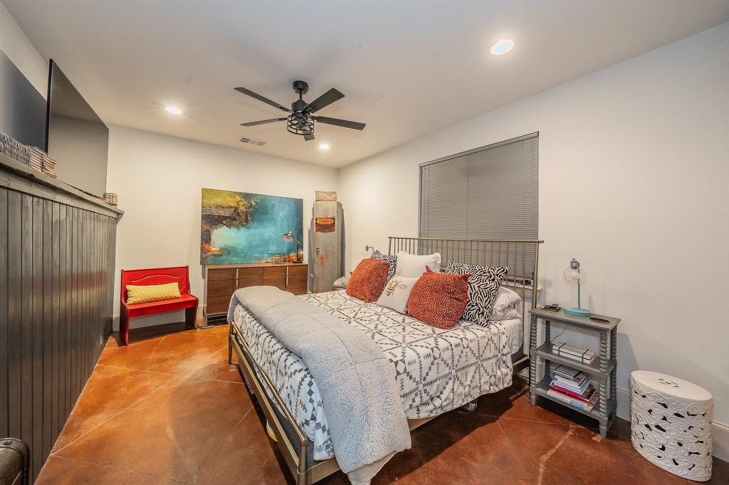 3911 Gilbert Avenue, Unit G Dallas, TX 75219 - Photo 6 of 35 a bedroom with a bed and a chandelier