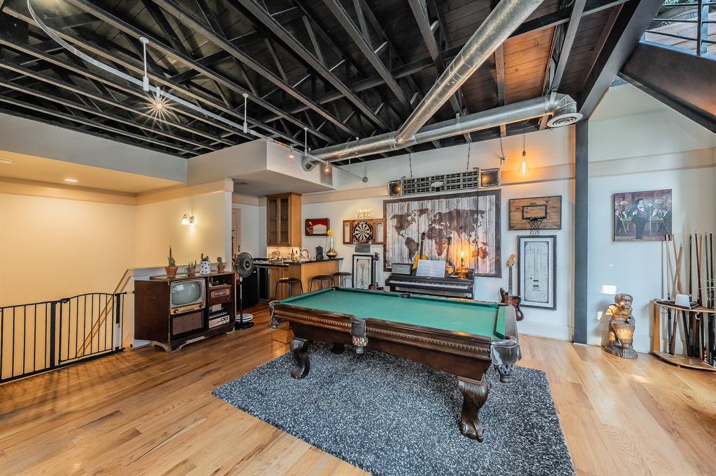 3911 Gilbert Avenue, Unit G Dallas, TX 75219 - Photo 9 of 35 a room with lots of furniture and a wooden floor