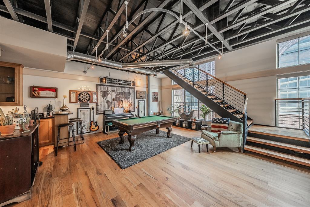 3911 Gilbert Avenue, Unit G Dallas, TX 75219 - Photo 10 of 35 a room with lots of wooden furniture and a wooden floor