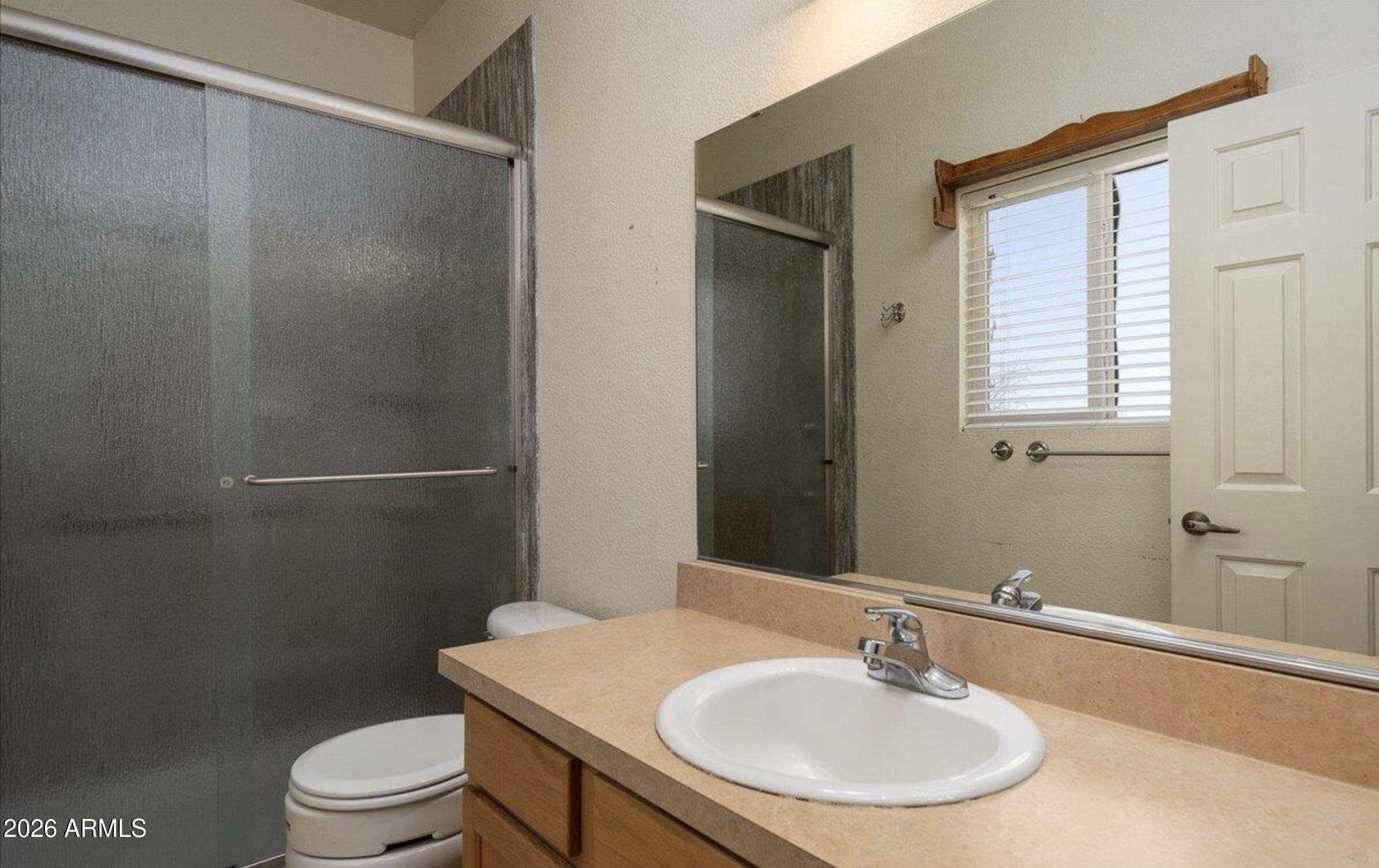 10193 East Windtalker Road Hereford, AZ 85615 - Photo 11 of 34 a bathroom with a sink toilet and shower