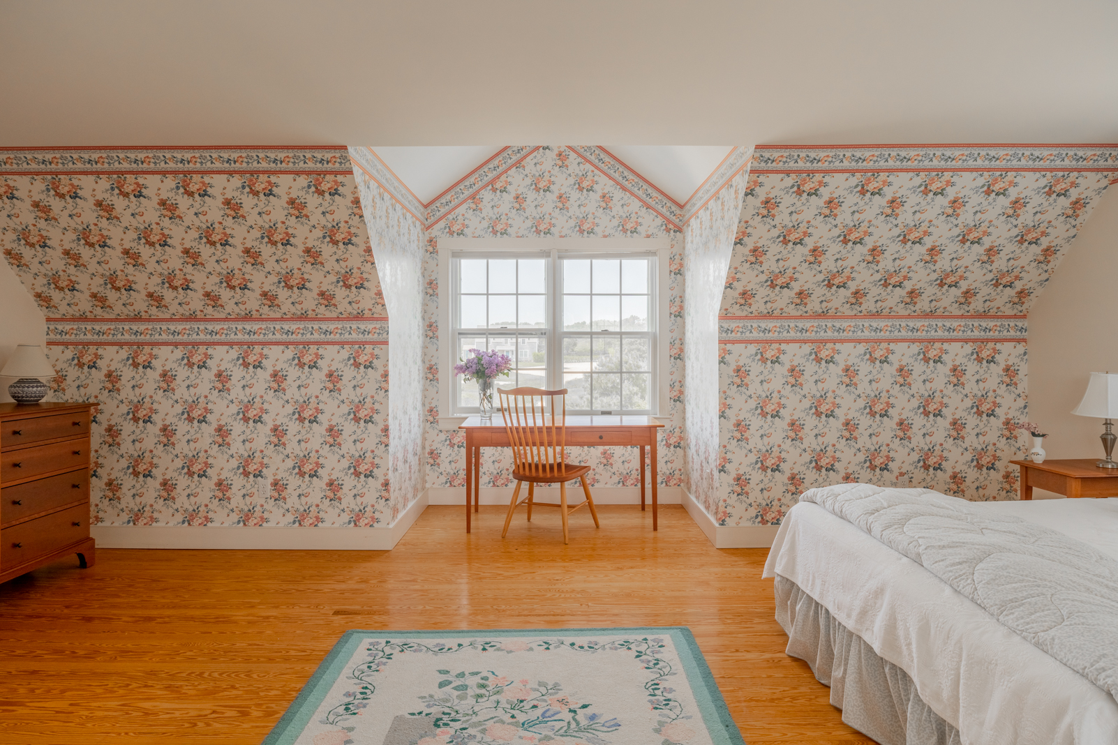 15 Swift Rock Road Nantucket, MA 02554 - Photo 31 of 32 a bedroom with a bed and a chair with the wooden floor