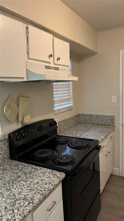 a close view of a stove a microwave and cabinets