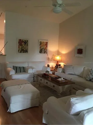 a living room with furniture and a lamp