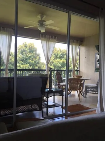 a living room with a floor to ceiling window and wooden floor