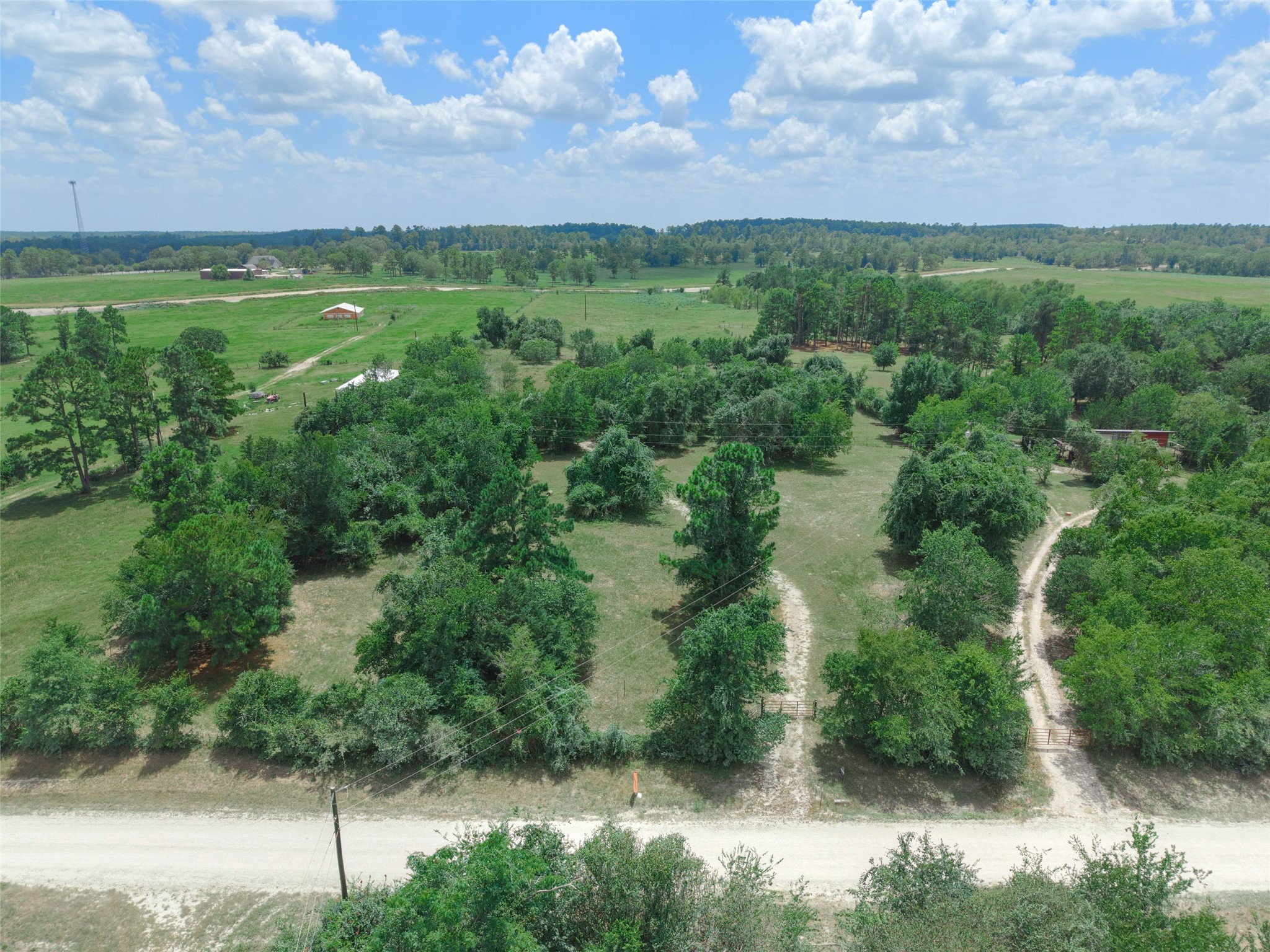 -tbd Davis Road Huntsville, TX 77340 - Photo 1 of 10 A beautiful aerial view showcases the property’s natural setting with mature trees and wide-open surroundings.