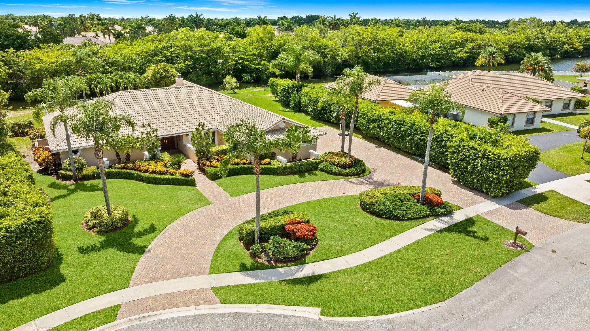 11937 Sandlake Drive Boca Raton, FL 33428 - Photo 2 of 54 a view of a garden with a swimming pool