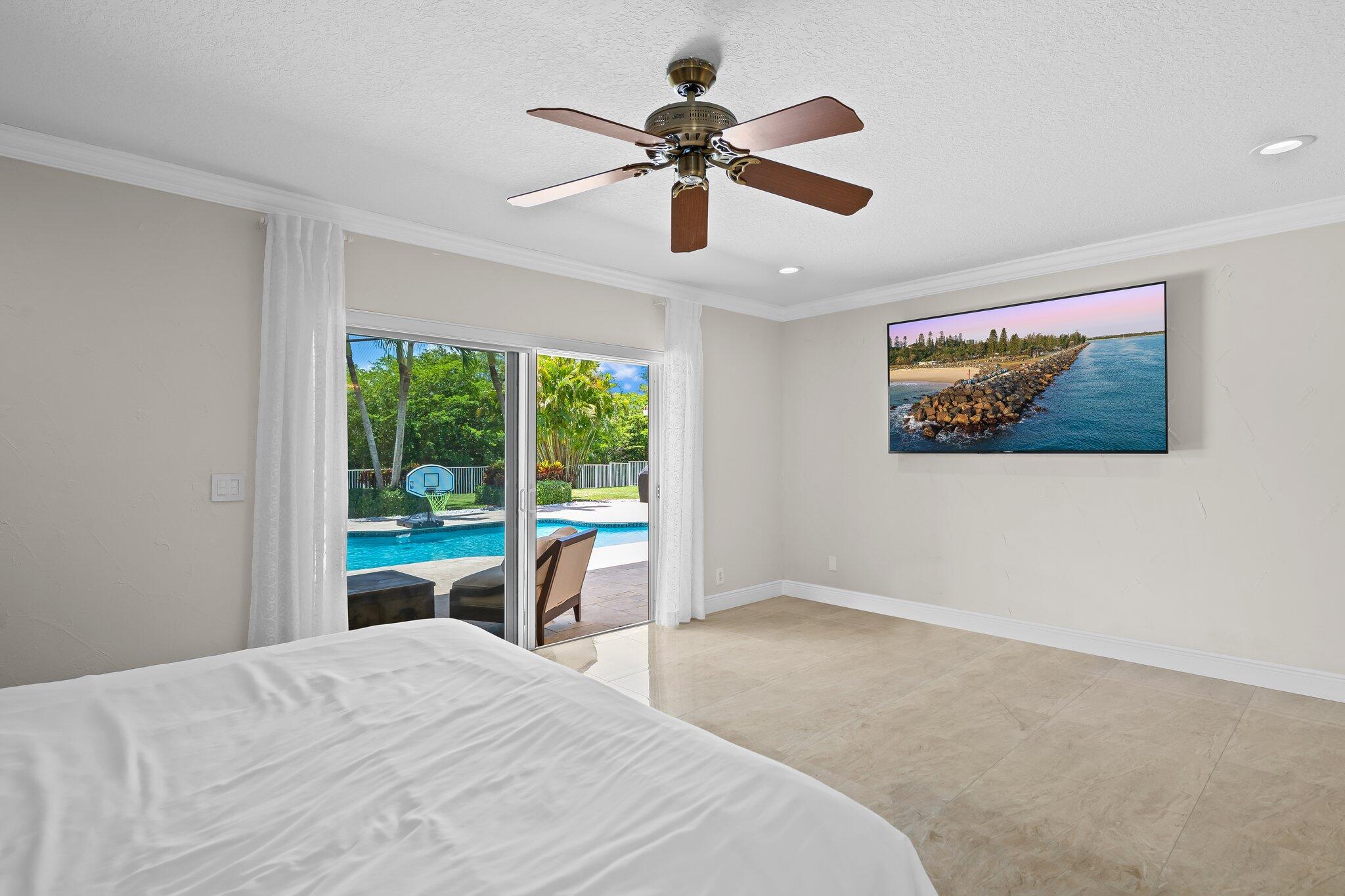 11937 Sandlake Drive Boca Raton, FL 33428 - Photo 28 of 54 a bedroom with a large bed and a window