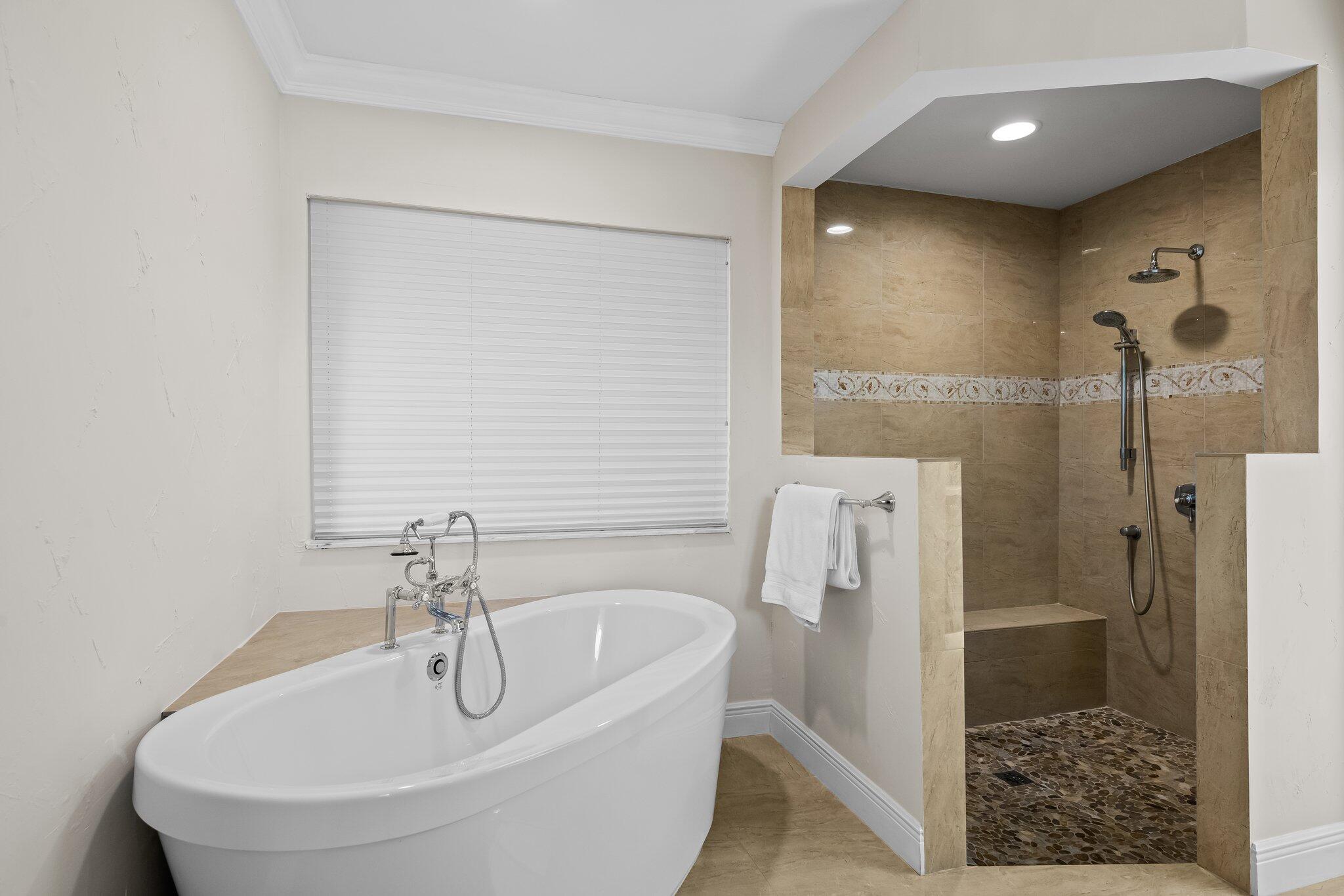 11937 Sandlake Drive Boca Raton, FL 33428 - Photo 31 of 54 a bathroom with a bathtub and a shower