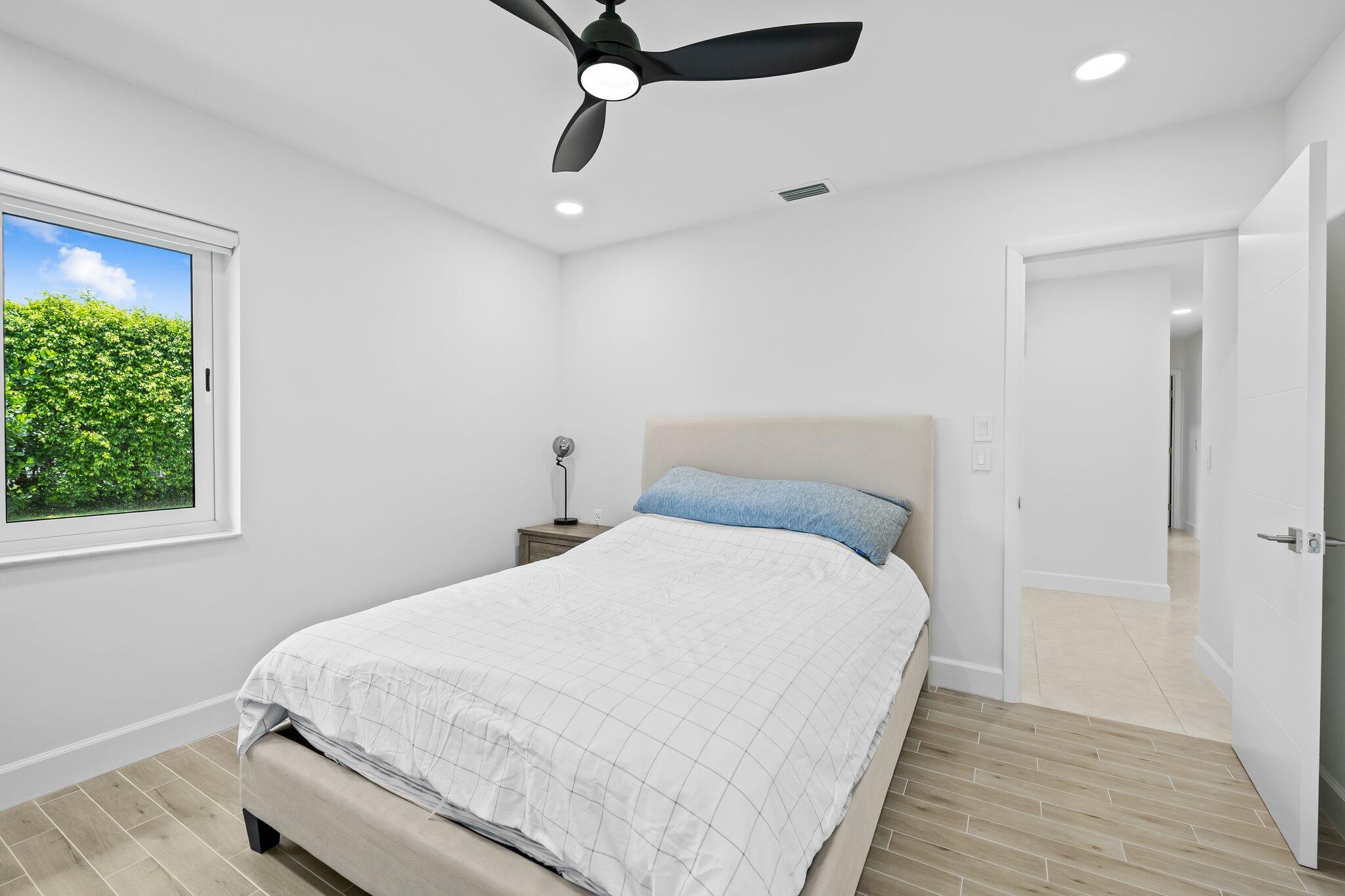 11937 Sandlake Drive Boca Raton, FL 33428 - Photo 33 of 54 a bedroom with a bed and a window