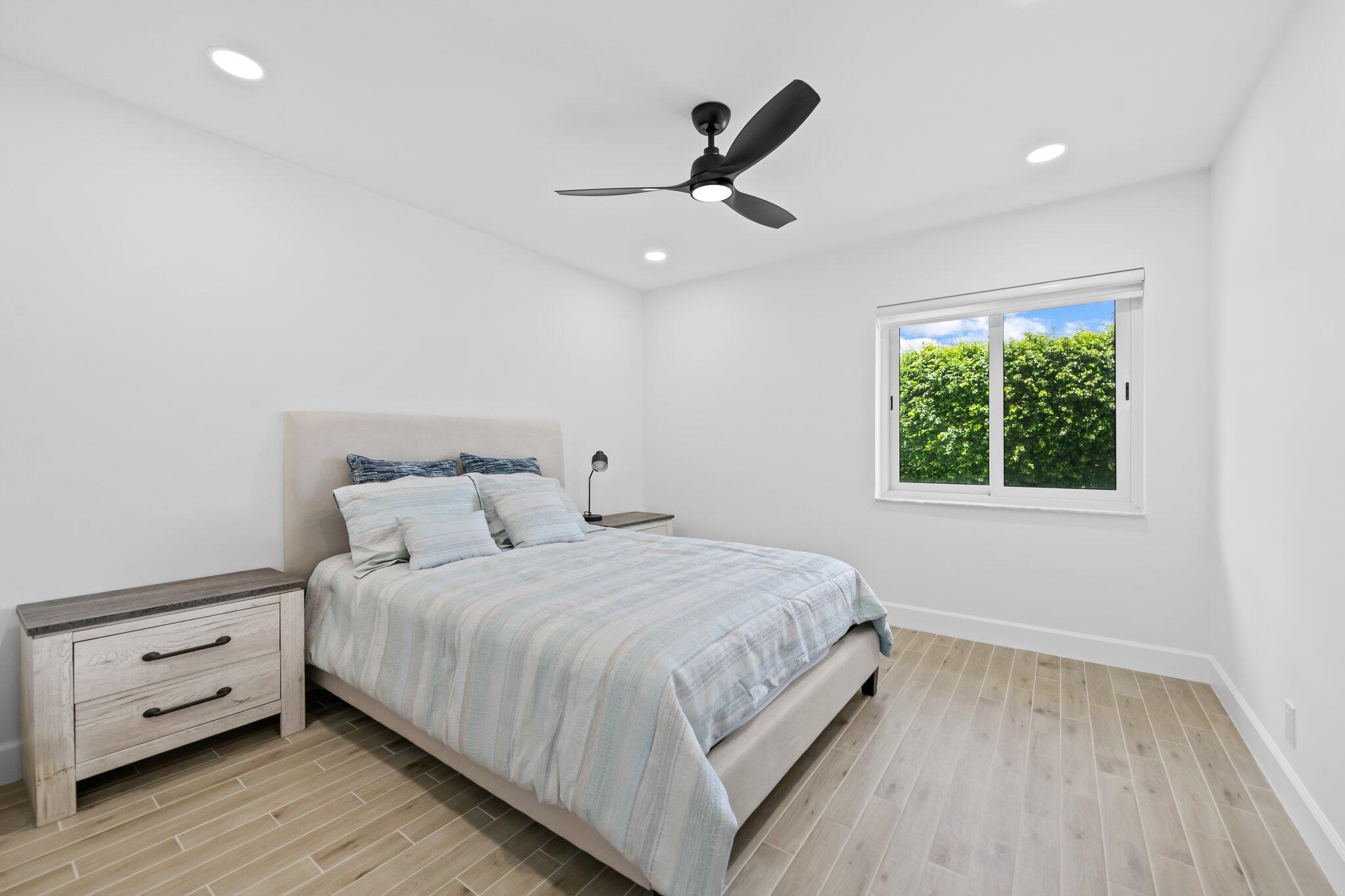 11937 Sandlake Drive Boca Raton, FL 33428 - Photo 36 of 54 a bedroom with a large bed and a window