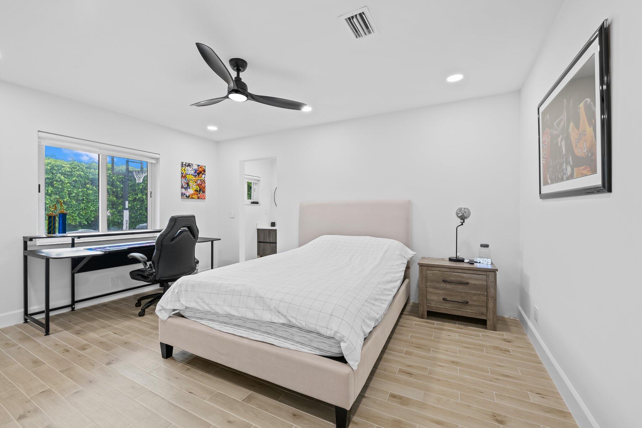 11937 Sandlake Drive Boca Raton, FL 33428 - Photo 38 of 54 a bedroom with a bed and a desk