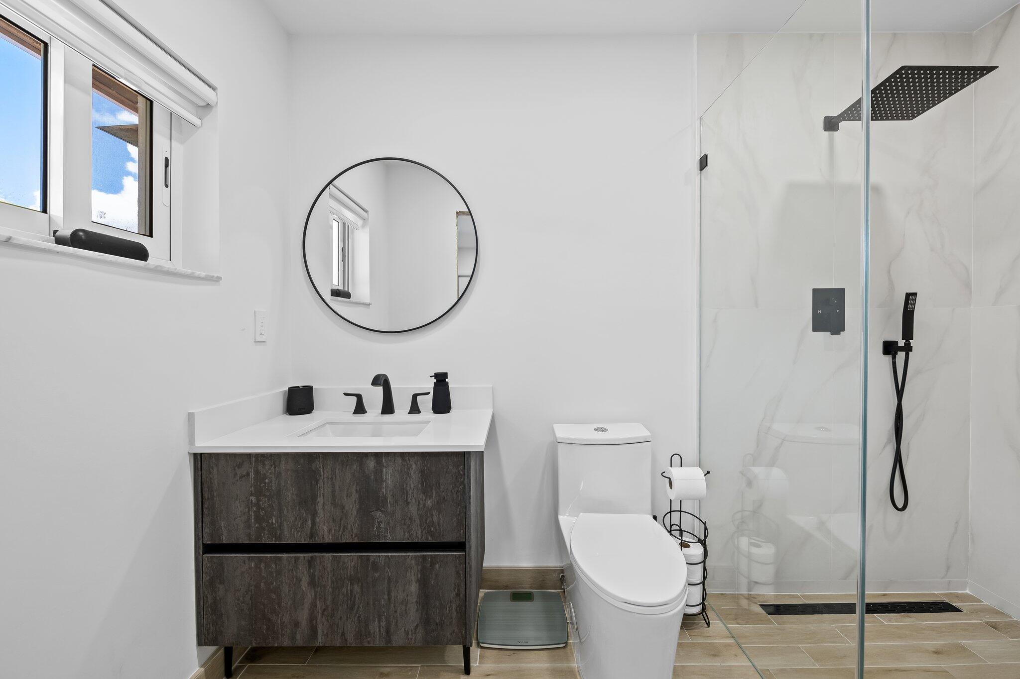 11937 Sandlake Drive Boca Raton, FL 33428 - Photo 40 of 54 a bathroom with a sink a toilet and a mirror