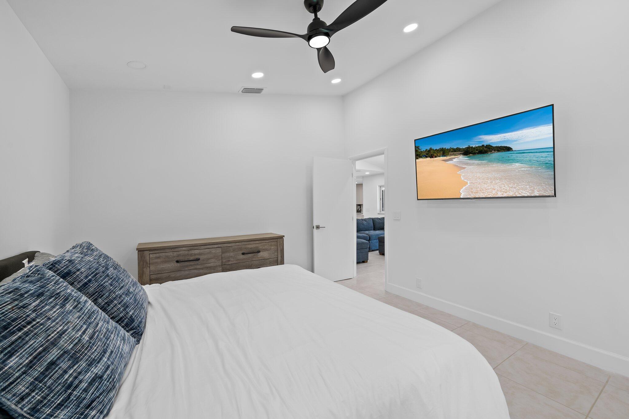 11937 Sandlake Drive Boca Raton, FL 33428 - Photo 43 of 54 a bedroom with a bed and a painting on the wall