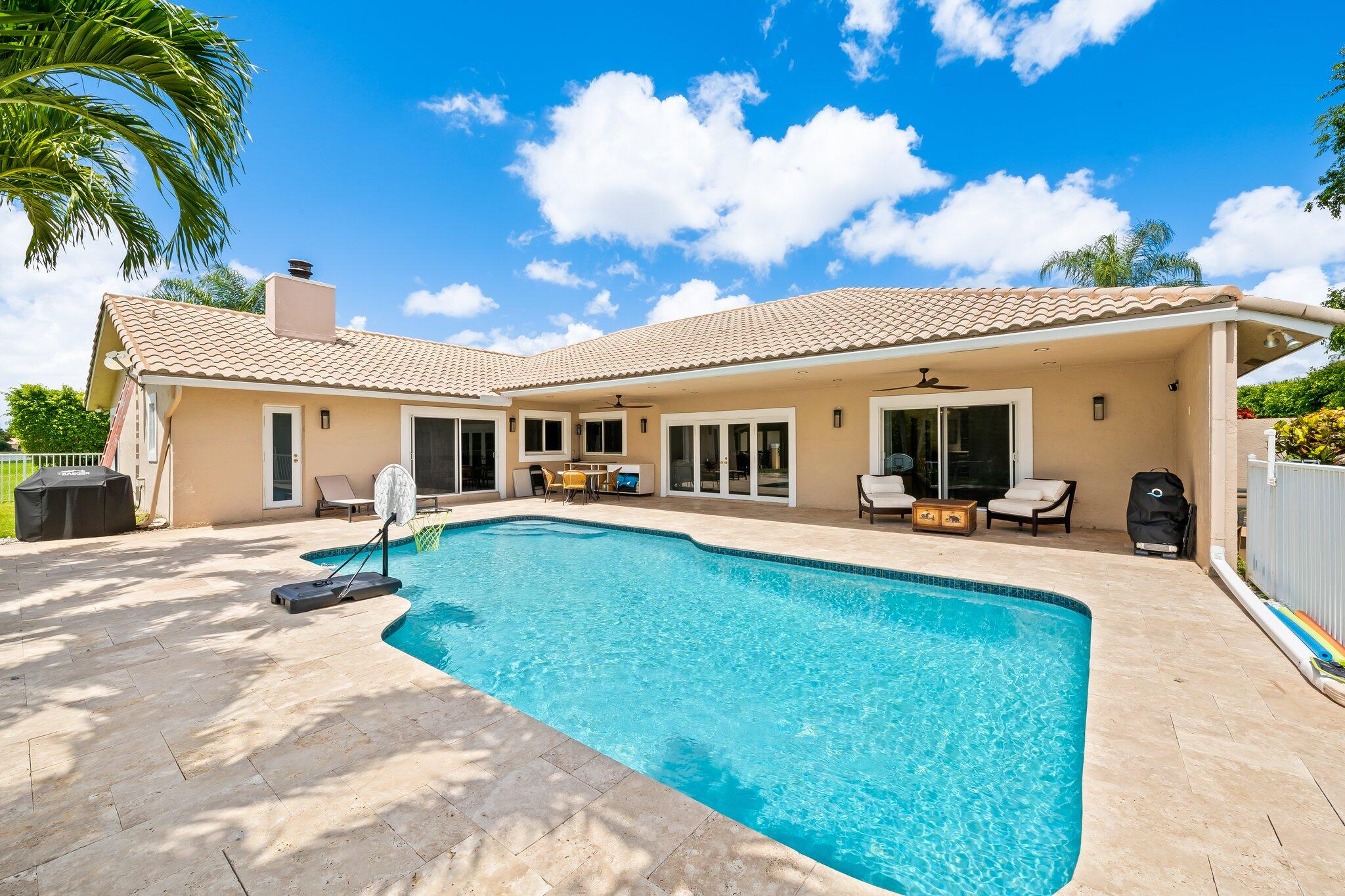 11937 Sandlake Drive Boca Raton, FL 33428 - Photo 47 of 54 a view of a house with swimming pool and a yard