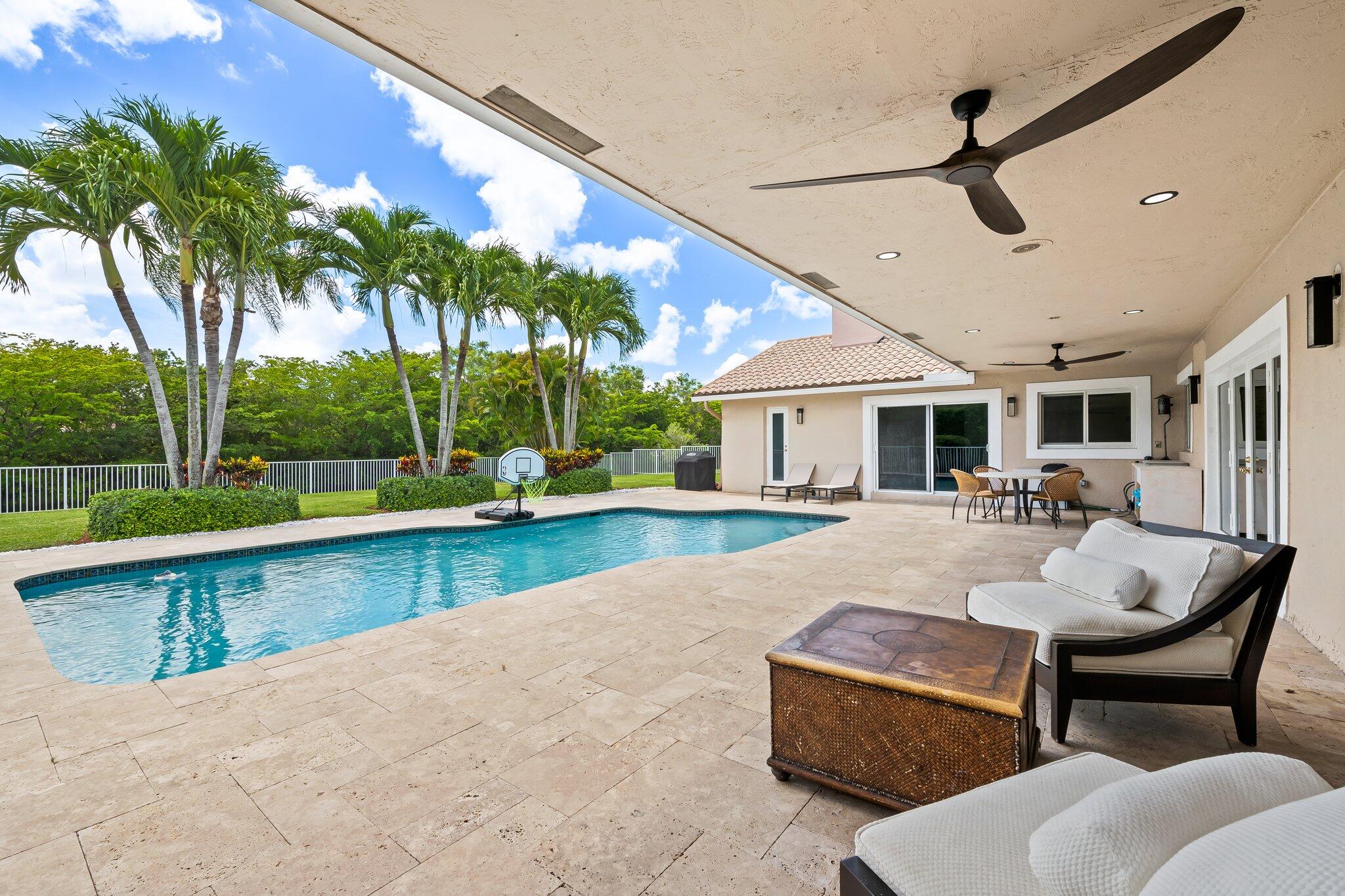 11937 Sandlake Drive Boca Raton, FL 33428 - Photo 48 of 54 a view of a patio with swimming pool table and chairs