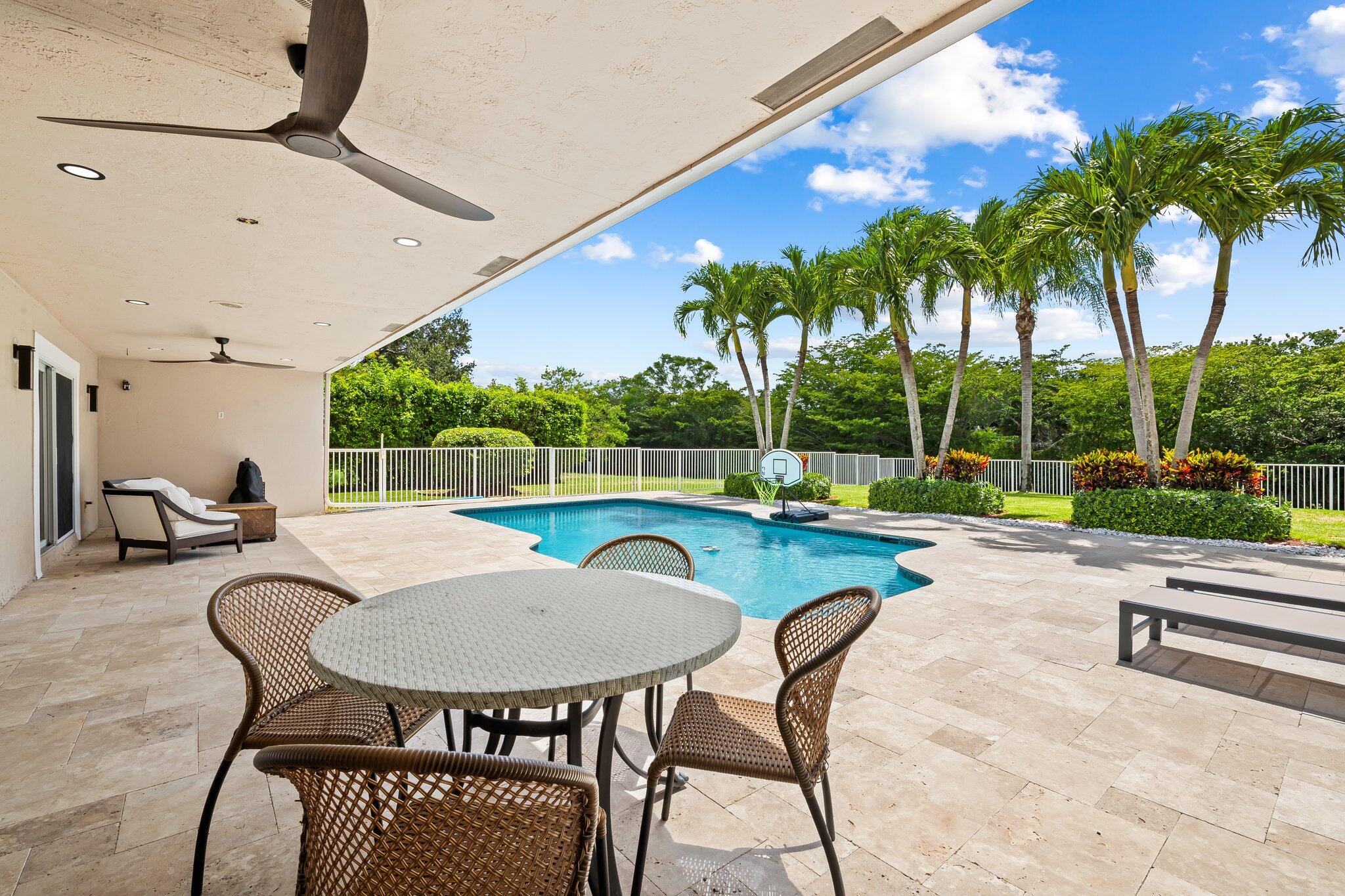 11937 Sandlake Drive Boca Raton, FL 33428 - Photo 49 of 54 a view of a backyard with swimming pool and sitting area