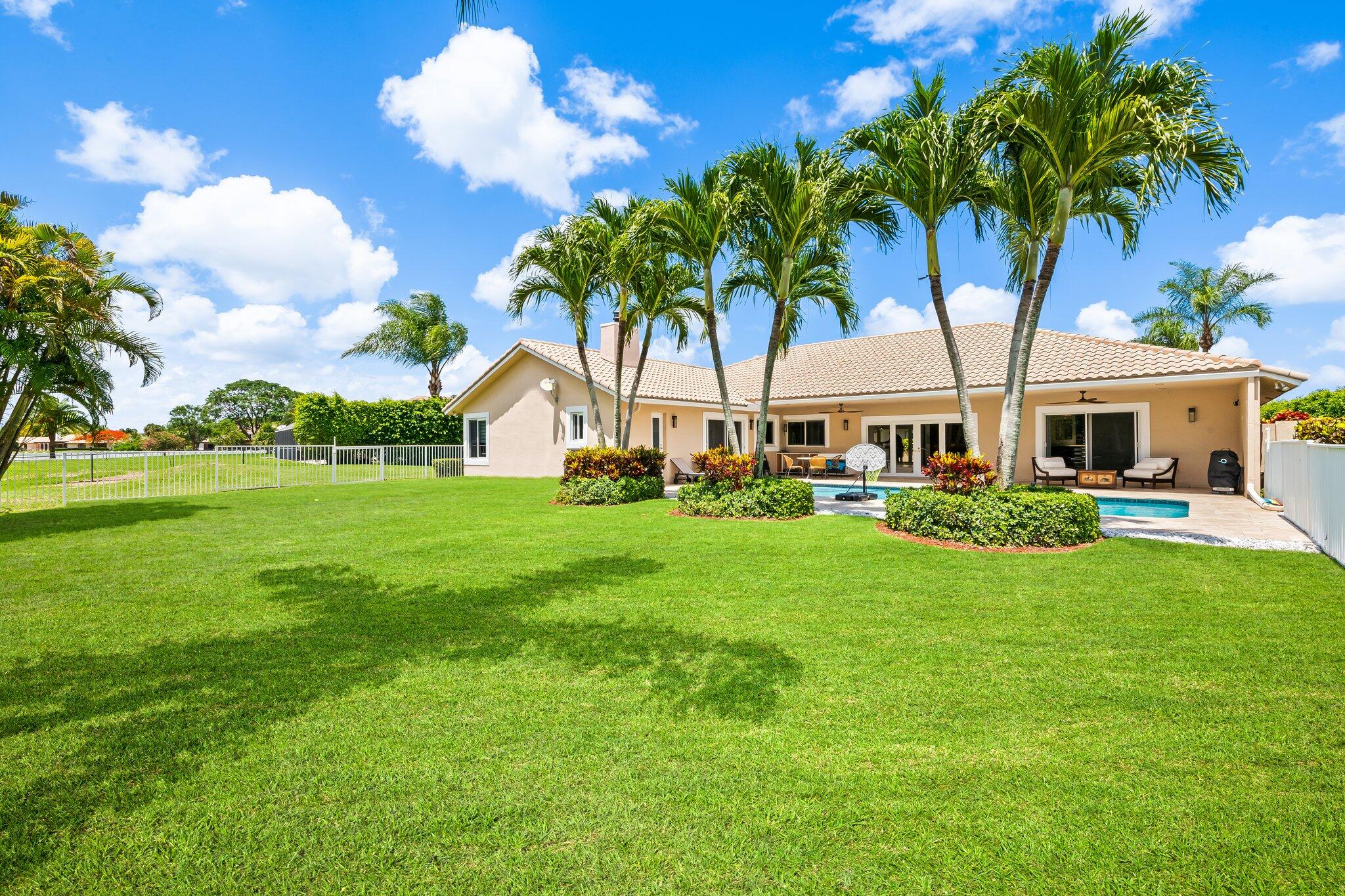 11937 Sandlake Drive Boca Raton, FL 33428 - Photo 51 of 54 a front view of a house with garden