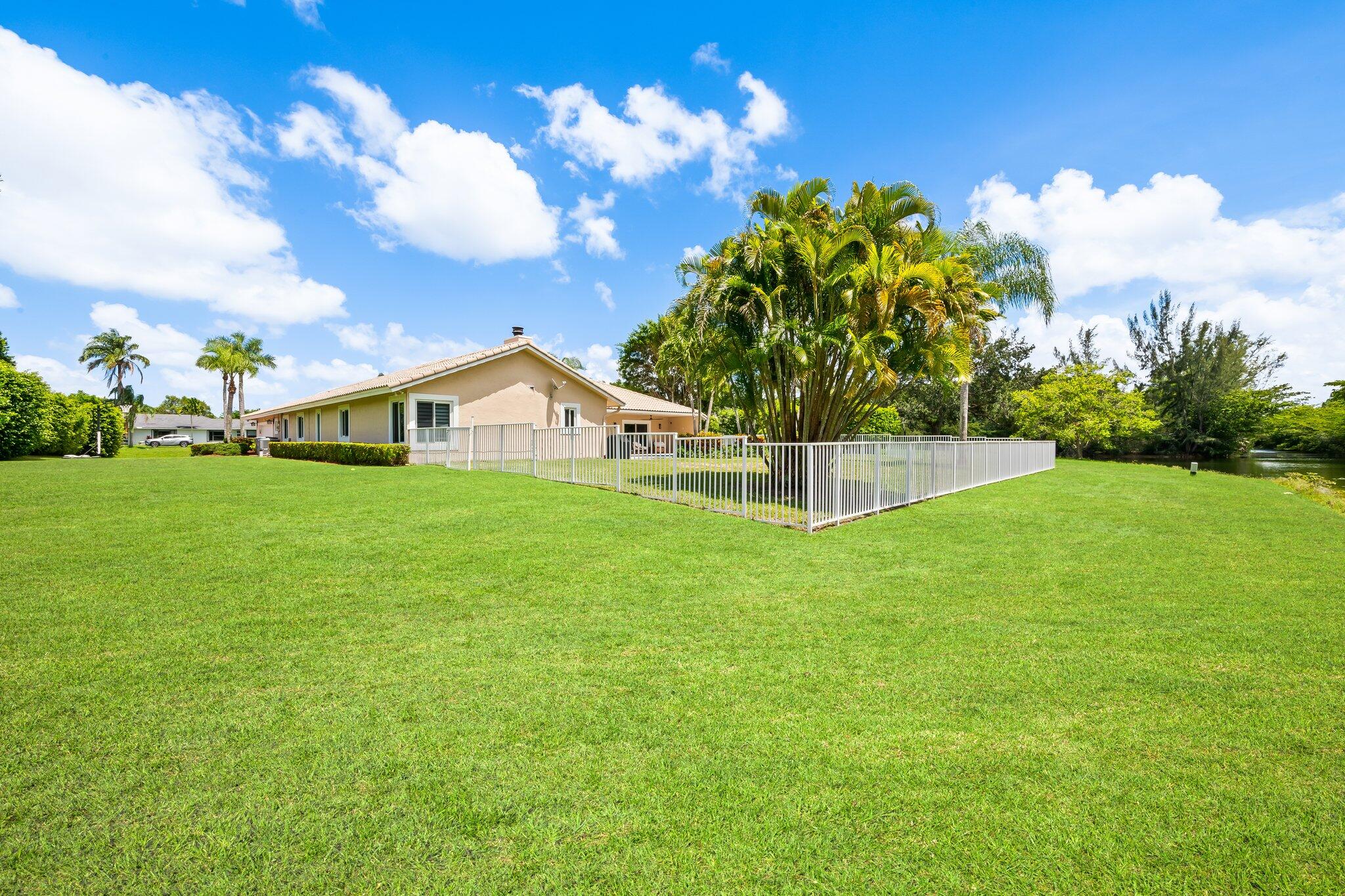 11937 Sandlake Drive Boca Raton, FL 33428 - Photo 52 of 54 a view of a house with a yard