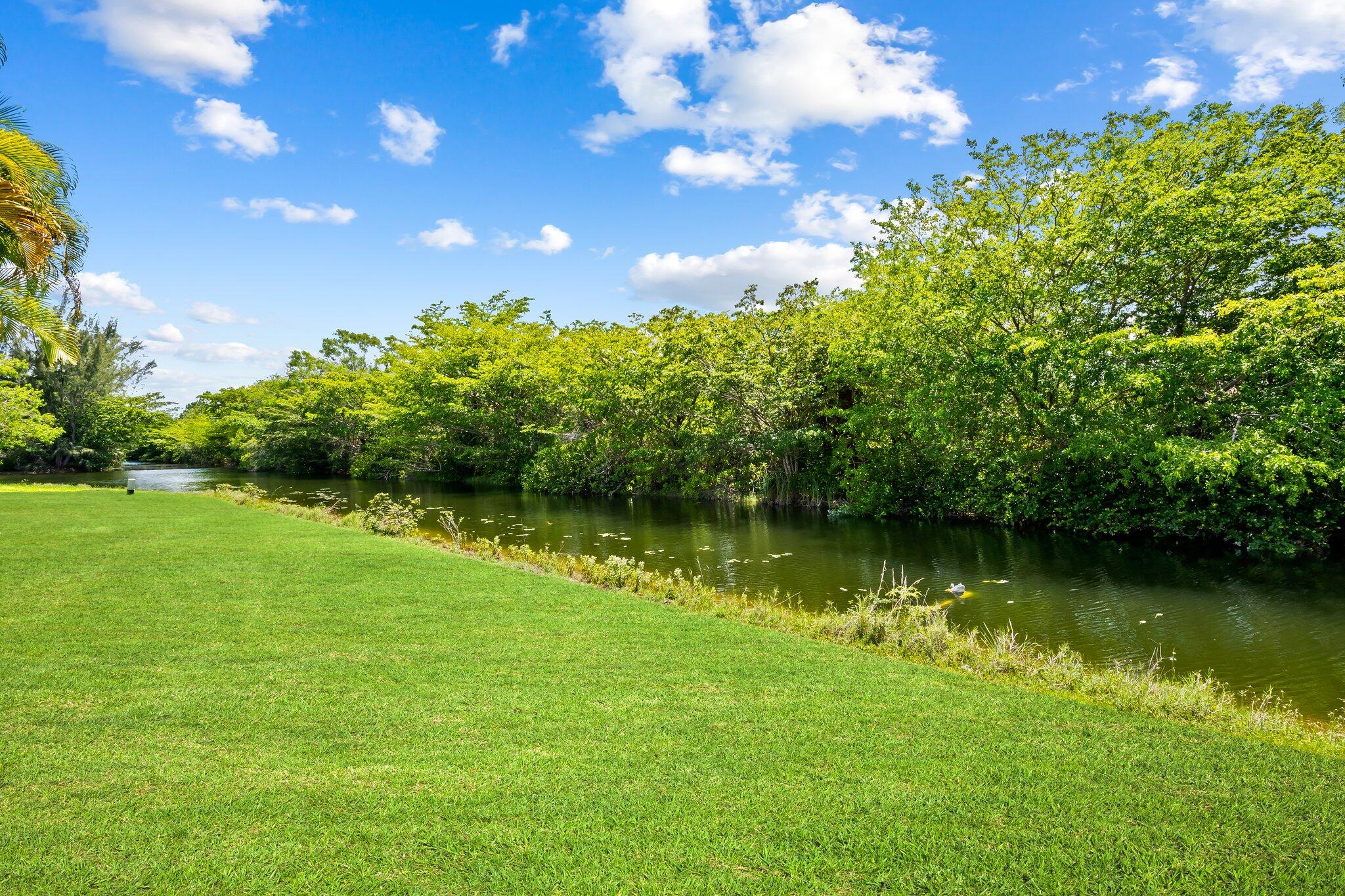 11937 Sandlake Drive Boca Raton, FL 33428 - Photo 53 of 54 a view of a lake with a yard