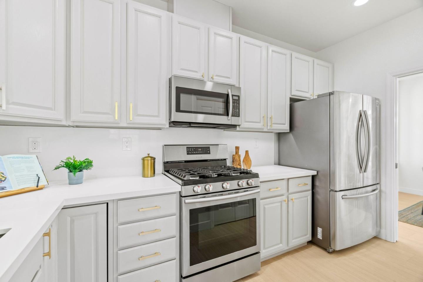 107 Beacon Street Mountain View, CA 94040 - Photo 11 of 55 a kitchen with granite countertop white cabinets and stainless steel appliances