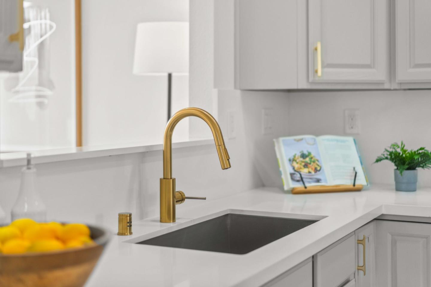 107 Beacon Street Mountain View, CA 94040 - Photo 14 of 55 a kitchen with a sink and a stove with white cabinet