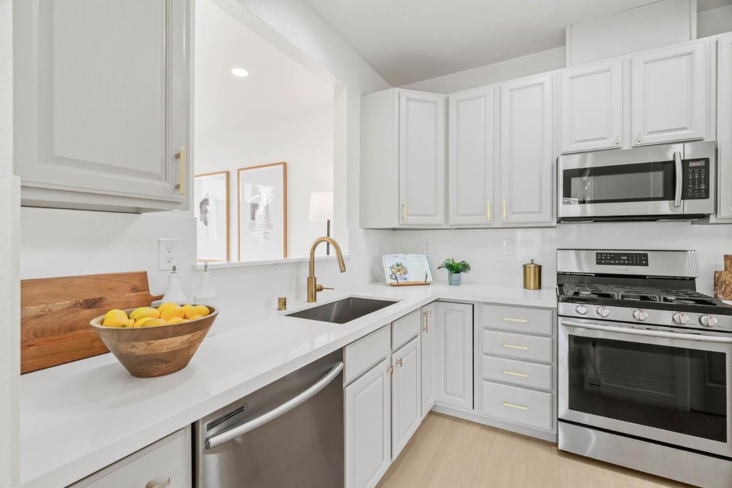 107 Beacon Street Mountain View, CA 94040 - Photo 10 of 55 a kitchen with stainless steel appliances white cabinets and a sink