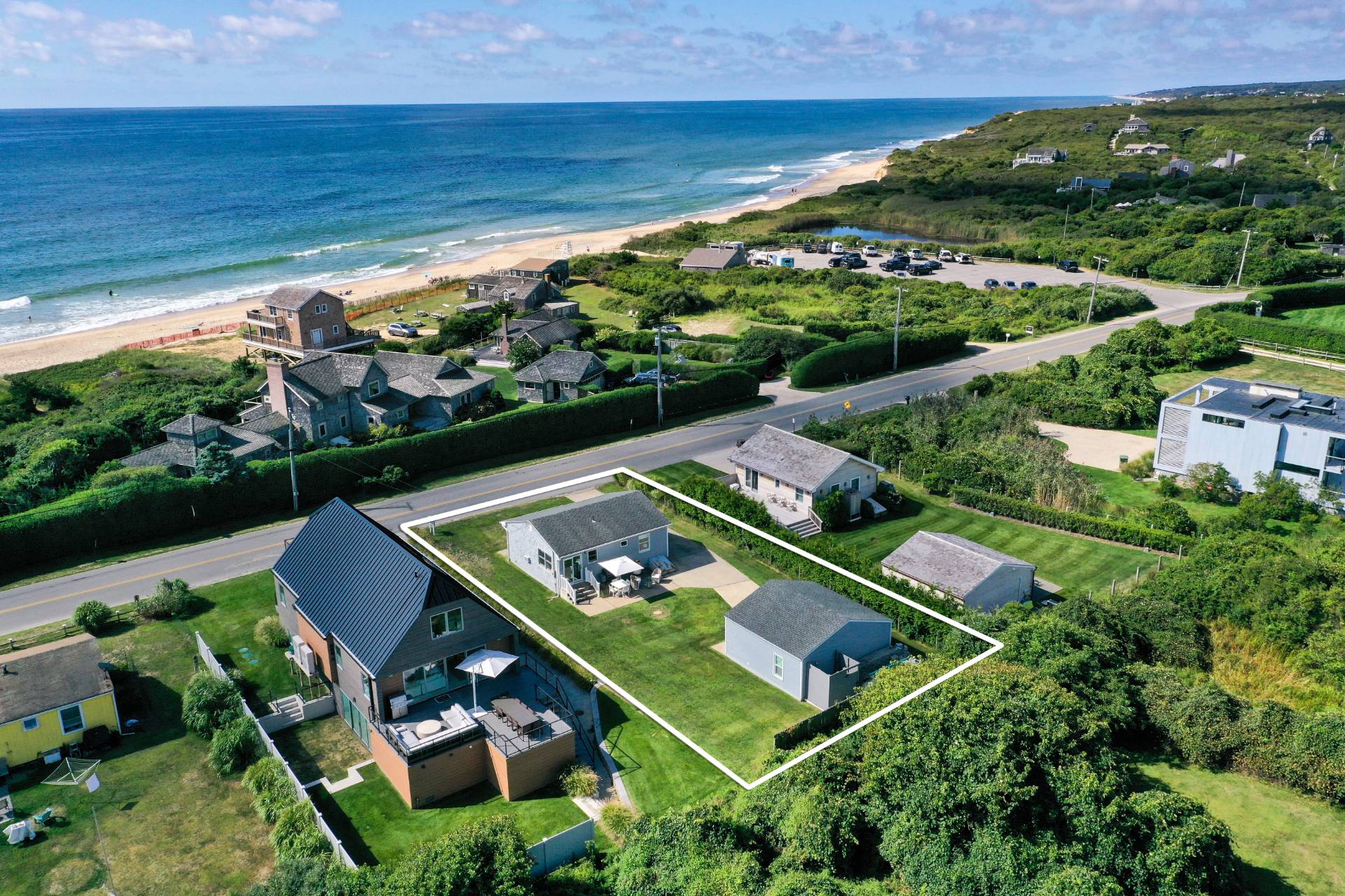 19 Deforest Road Montauk, NY 11954 - Photo 2 of 20 an aerial view of a tennis ground and a houses