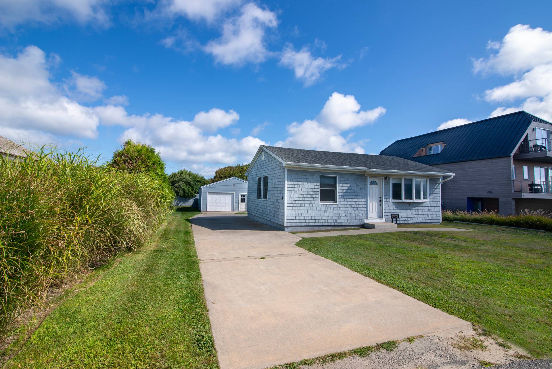 19 Deforest Road Montauk, NY 11954 - Photo 4 of 20 a front view of a house with a garden and yard