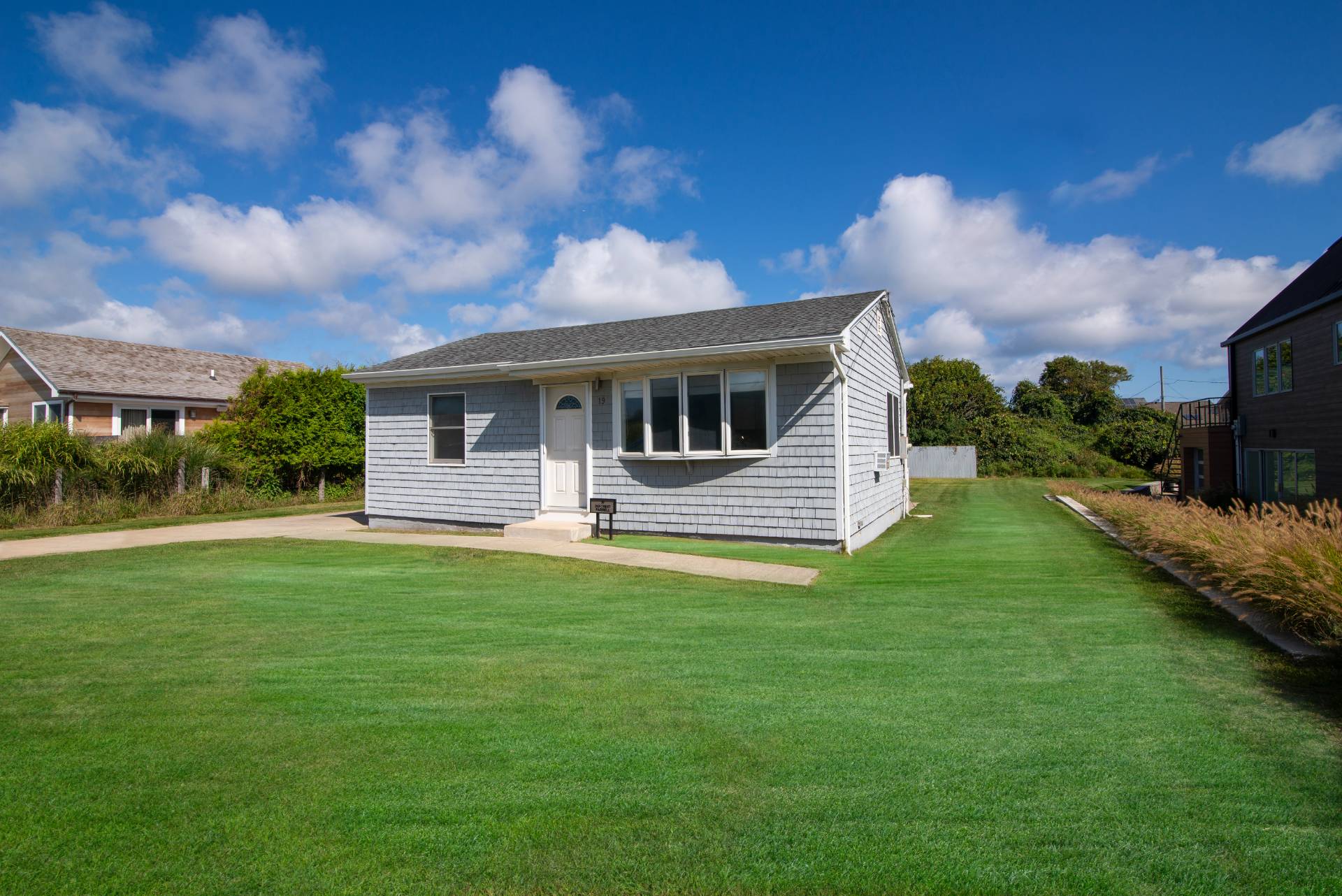 19 Deforest Road Montauk, NY 11954 - Photo 5 of 20 a front view of a house with a garden