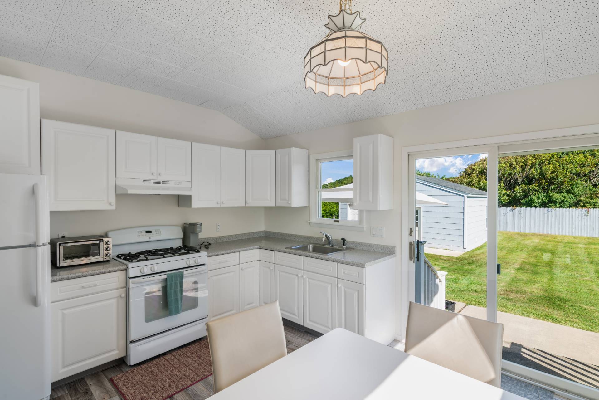 19 Deforest Road Montauk, NY 11954 - Photo 9 of 20 a kitchen with white cabinets and appliances