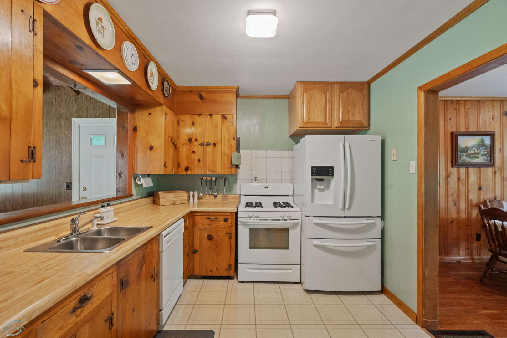 583 Riedy Road Lisle, IL 60532 - Photo 9 of 24 a kitchen with a stove a sink and a refrigerator