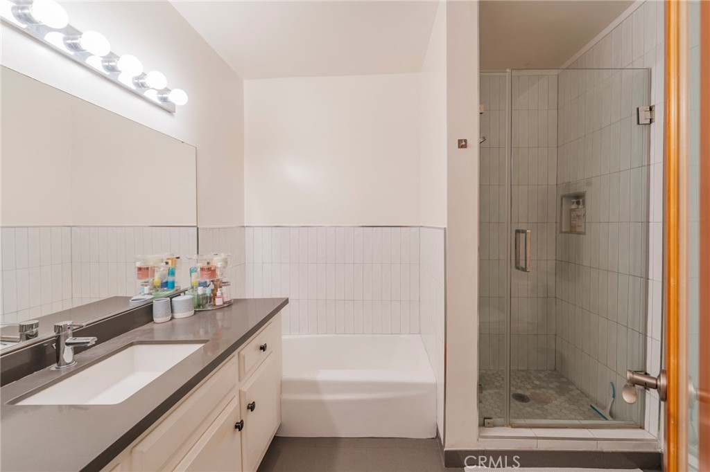 8710 Delgany Avenue, Unit 3 Playa del Rey, CA 90293 - Photo 7 of 34 a bathroom with a granite countertop sink a mirror and a shower