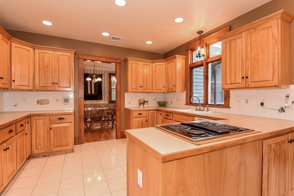 20 Harriman Road Merrimac, MA 01860 - Photo 13 of 30 a kitchen with stainless steel appliances granite countertop a stove a sink dishwasher and a refrigerator with wooden cabinets