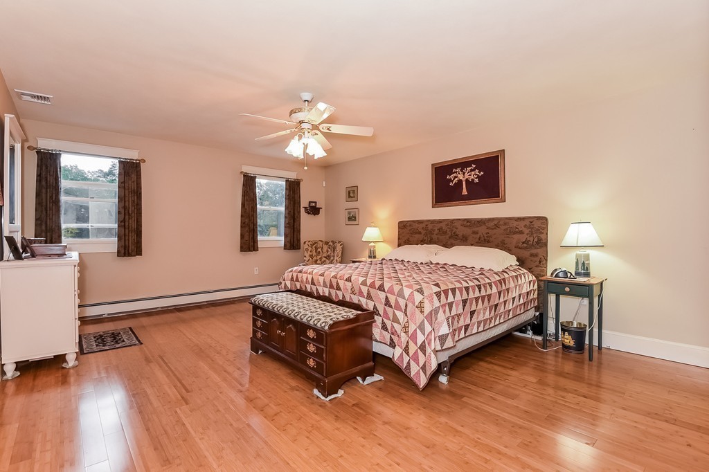 20 Harriman Road Merrimac, MA 01860 - Photo 16 of 30 a spacious bedroom with a bed a chandelier and a dresser