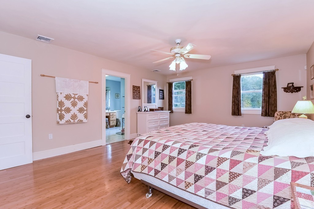 20 Harriman Road Merrimac, MA 01860 - Photo 17 of 30 a bedroom with a large bed and a chandelier
