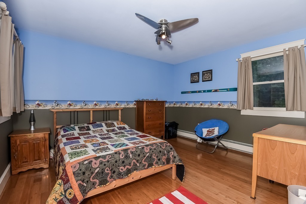 20 Harriman Road Merrimac, MA 01860 - Photo 19 of 30 a bedroom with a bed and a chandelier