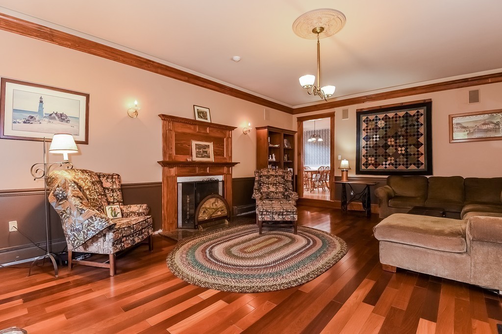 20 Harriman Road Merrimac, MA 01860 - Photo 2 of 30 a living room with furniture a fireplace and a chandelier