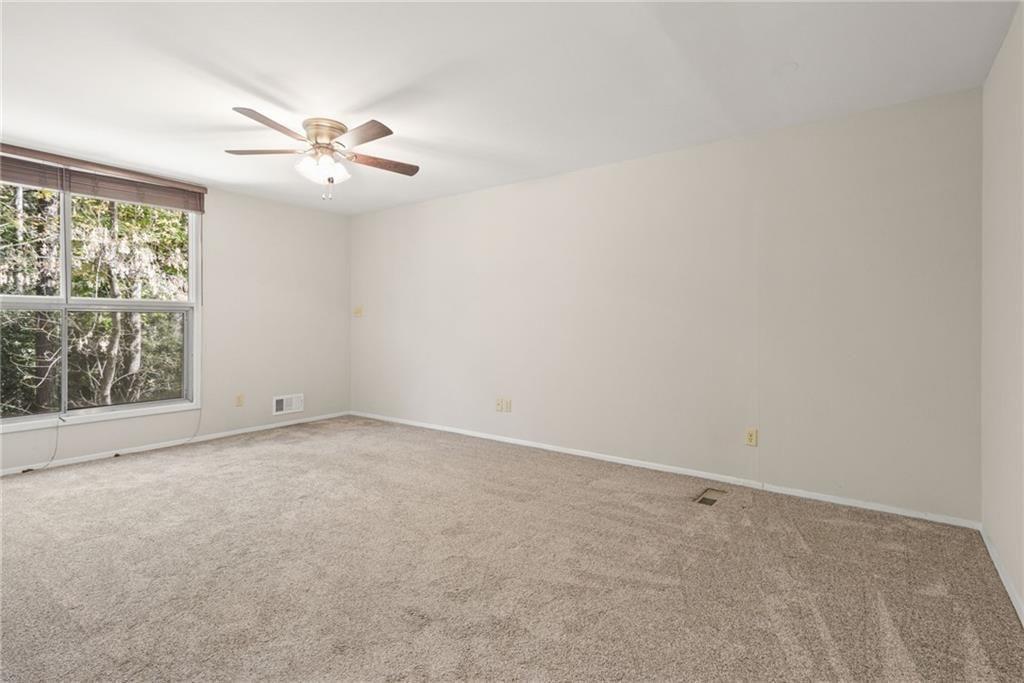705 Edgewater Trail Sandy Springs, GA 30328 - Photo 21 of 36 an empty room with windows and fan