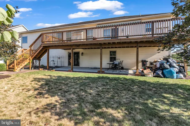 a kitchen with stainless steel appliances granite countertop a refrigerator a stove and a sink with cabinets