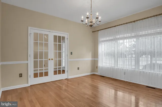 a view of an empty room with closet and a window