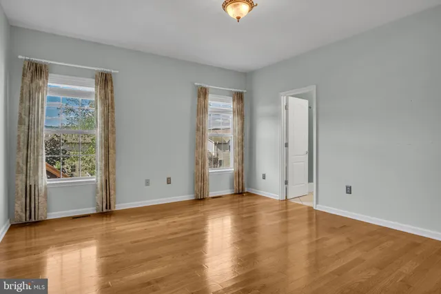 a view of a room with wooden floor