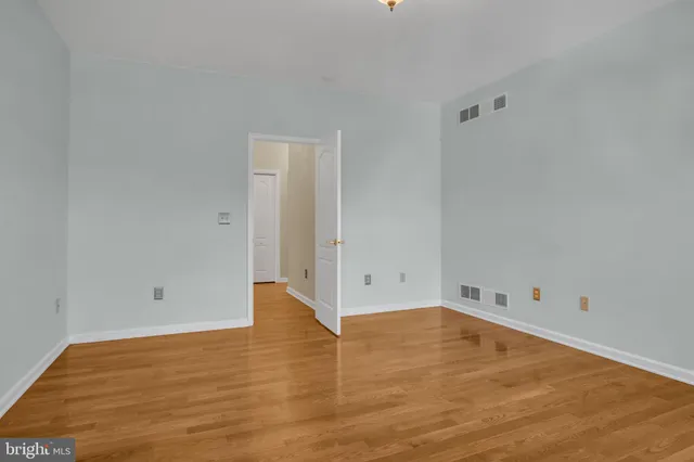 a view of an empty room and wooden floor