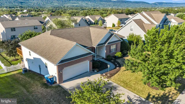 a view of a house with a yard and sitting area