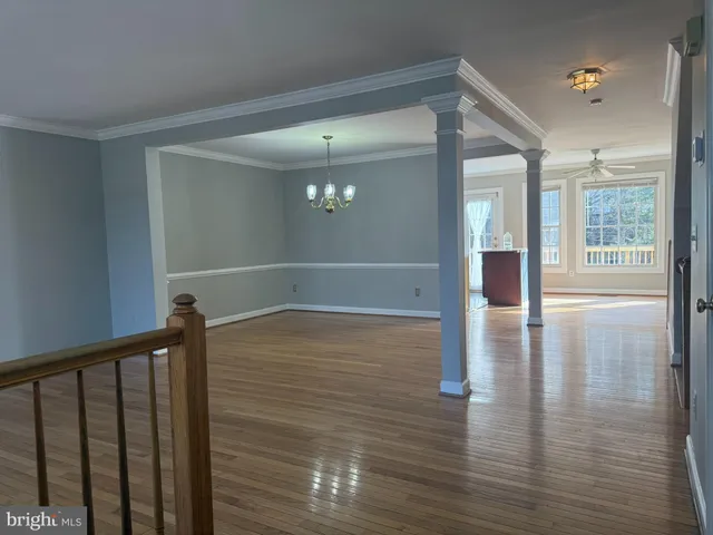 a view of interior space with wooden floor and staircase