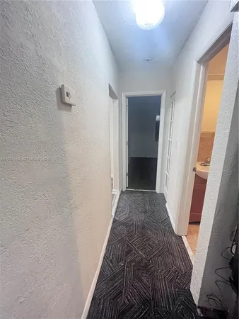 a view of hallway with wooden floor