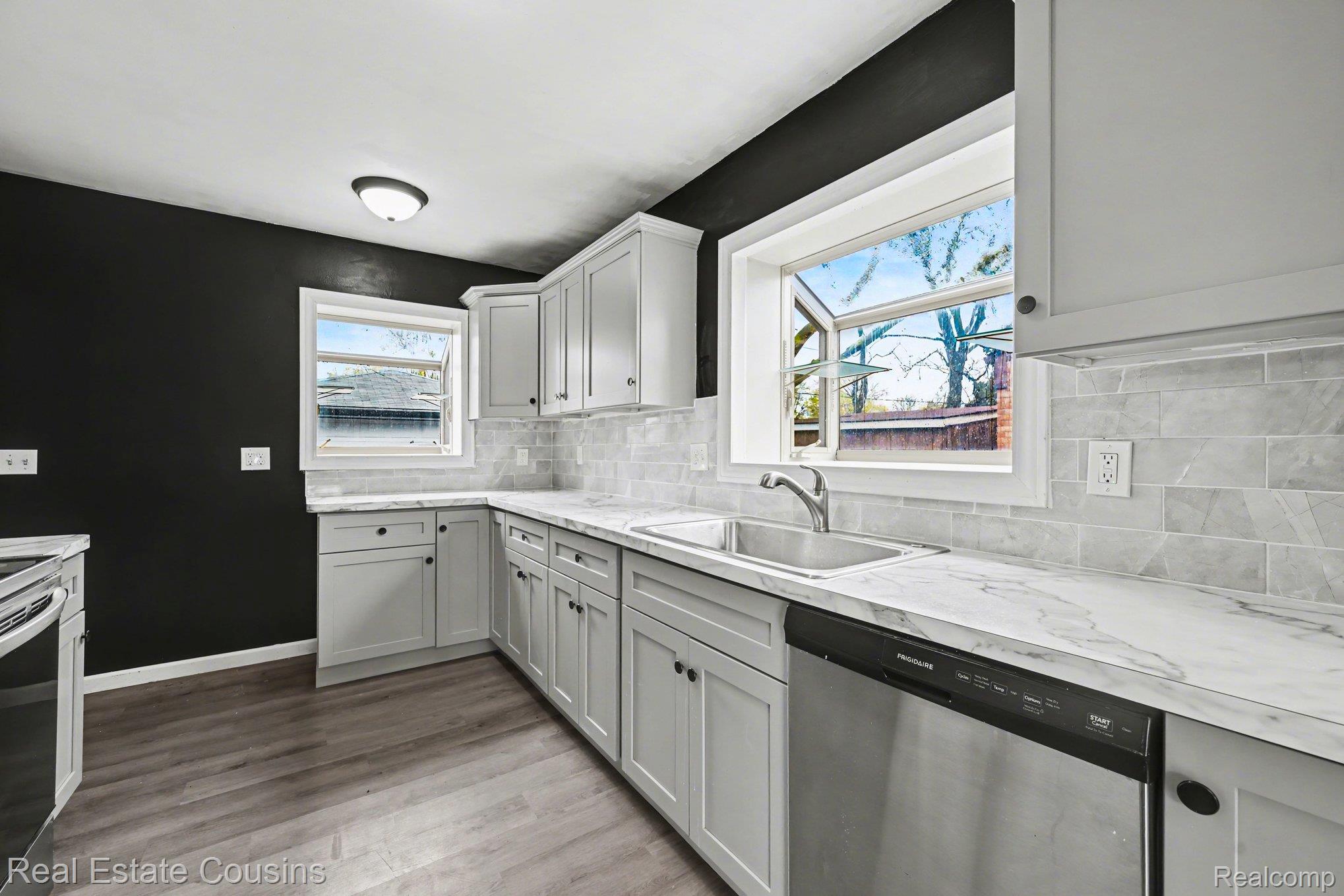 32224 Joy Road Livonia, MI 48150 - Photo 10 of 33 Kitchen featuring stainless steel appliances, decorative backsplash, and light wood-type flooring