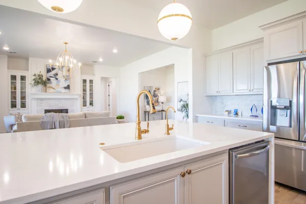 a kitchen with kitchen island a sink stainless steel appliances and cabinets