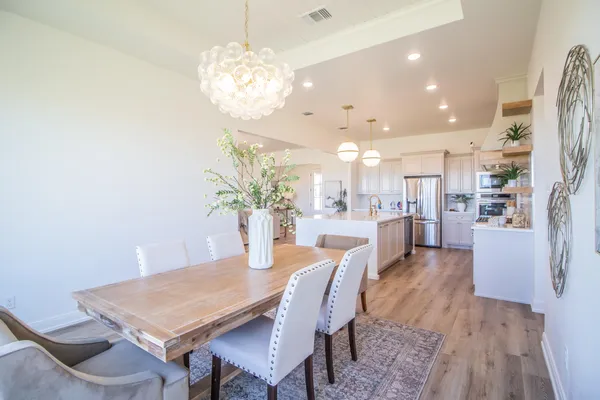 a view of a dining room with furniture and wooden floor