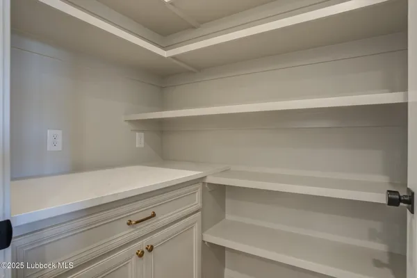 a spacious bathroom with double sink a mirror a toilet and a shower